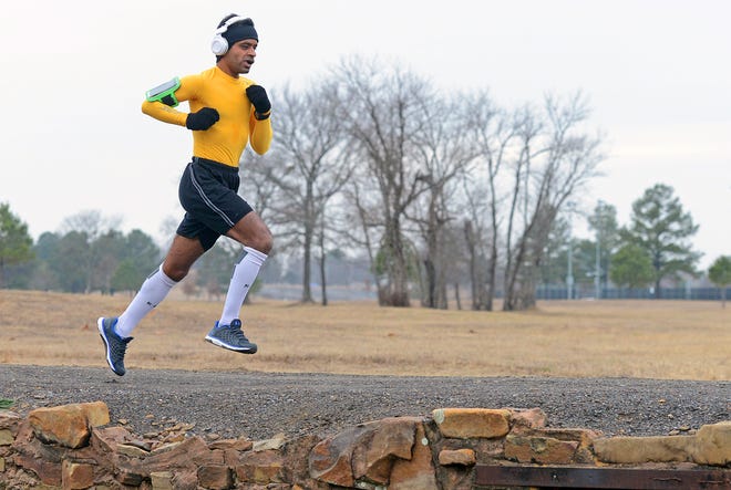 Pavan Gorukanti runs the fitness trail inside Ben Geren Park as a light rain falls Friday, Jan. 13, 2017. The chance of rain today is 50 percent with a high temperature of 50. BRIAN D. SANDERFORD/TIMES RECORD