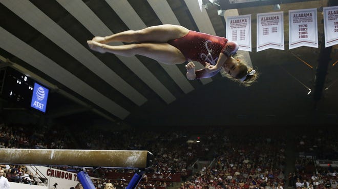 Alabama's Nickie Guerrero dismounts from balance beam during the first home meet against LSU at Coleman Coliseum in Tuscaloosa on Friday. Staff Photo/Erin Nelson