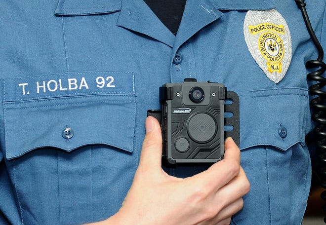 Burlington Township Officer Taylor Holba puts a body camera on at the Police Department on Wednesday, June 15, 2016.