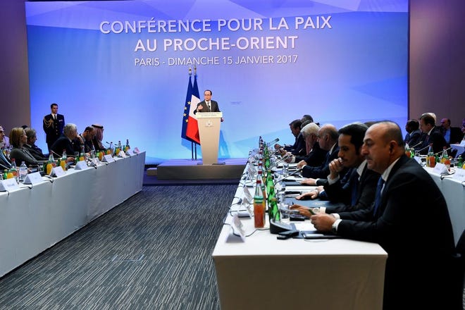 French President Francois Hollande delivers his speech at the opening of the Mideast peace conference in Paris on Sunday. Fearing a new eruption of violence in the Middle East, more than 70 world diplomats gathered in Paris on Sunday to push for renewed peace talks that would lead to a Palestinian state.