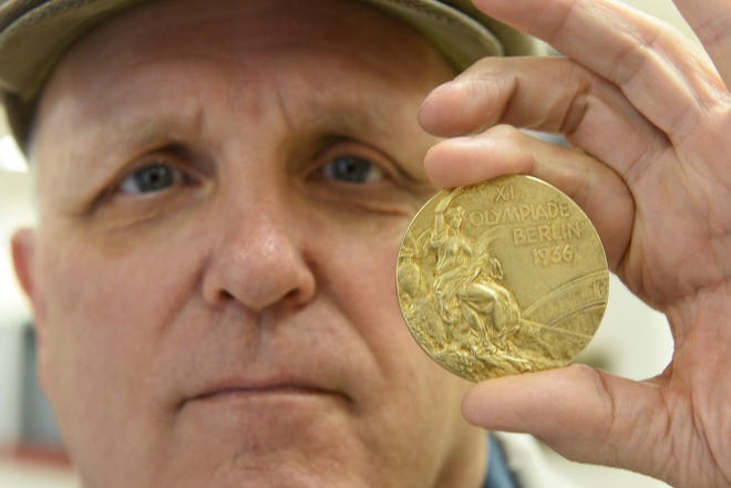 Oliver Fortenberry displays his father’s 1936 Olympic Gold Medal for basketball on Friday. The medal was appraised on PBS’ “Antiques Roadshow” scheduled to air tonight at 7 p.m. (Photos by Michael Schumacher/Amarillo Globe-News)