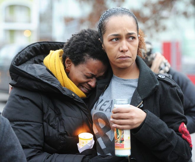 Mariza Moniz Carvalho and Helena Ribeiro weep during a candlelight vigil for Eugenia Monteiro on Saturday, Jan. 14, 2017. Monteiro was murdered by her boyfriend Matias Andrade.
