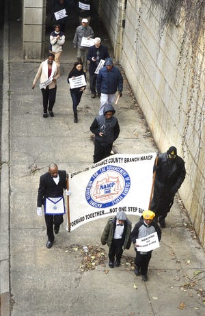 Community members march along South Church Street on Monday during annual Martin Luther King Jr. March. PHOTOS BY STEVEN MANTILLA / TIMES-NEWS