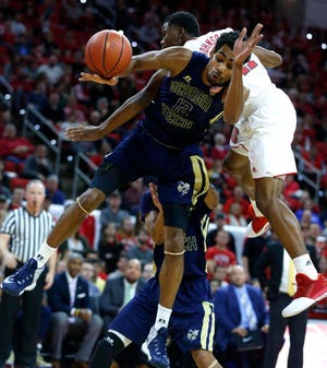 Georgia Tech's Quinton Stephens, front, and N.C. State's Markell Johnson compete for position Sunday night.