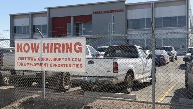 Prospects for employment in the Texas oil field are beginning to look up, as illustrated by a hiring sign in front of a Halliburton facility in Odessa in late December.Mark Sterkel/Odessa American