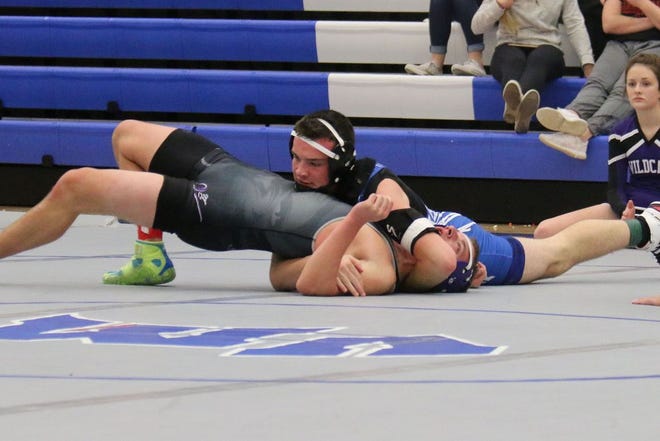 Caleb Button takes down an opponent in an earlier meet this season. He placed fourth at the Perry Invitational on Jan. 14.