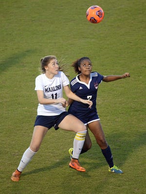 Arnold's Gabby Looker and Wakulla's Maya Howard eye the ball during Tuesday's District 2-3A semifinal match at Gavlak Stadium Tuesday. ANDREW WARDLOW/THE NEWS HERALD