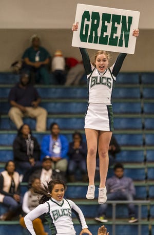 Courtney Deavers, right, and Ashley Aquilina perform with their fellow Shelton State cheerleaders during a men's basketball game on Thursday, Dec. 8, 2016, at Shelton State Community College in Tuscaloosa, Ala. Photo/Laura Chramer