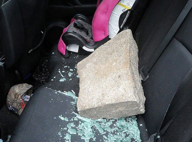Brockton police officer Nichole Anderson-Pierce threw this large rock through the back window of a car after the driver overdosed and caused a crash, Tuesday, Jan. 17, 2017.
