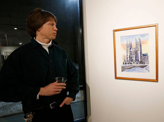 Artist Edward Brey looks over his work that he painted in Maine, Feb.11, 2016 during the opening night of the Enso Art Gallery in Brockton.