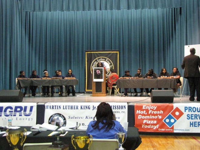 Teams taking part in the Black History and Cultural Brain Bowl Competition were winners Caring and Sharing Learning School, left, and runner-up Lincoln Middle School. Center is moderator Yvette Carter. Photos by Aida Mallard/Special to the Guardian