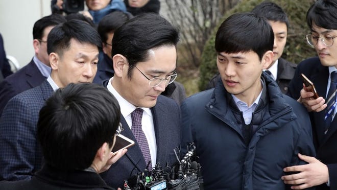 Lee Jae-yong, vice chairman of Samsung Electronics Co. is questioned by reporters as he leaves after attending the hearing at the Seoul Central District Court in Seoul, South Korea, Wednesday, Jan. 18, 2017.