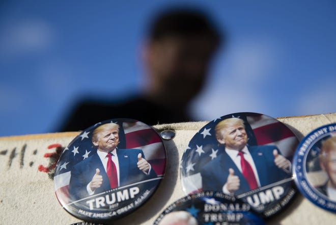 In this Jan. 18, 2017, photo, buttons for sale are posted as preparations continue for Friday's inauguration of Donald Trump in Washington. (AP Photo/Matt Rourke)