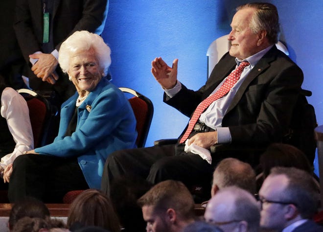FILE - In this Thursday, Feb. 25, 2016 file photo, former President George H. W. Bush, right, and his wife, Barbara, are greeted before a Republican presidential primary debate at The University of Houston in Houston. On Wednesday, Jan. 18, 2017, the former president was admitted to an intensive care unit, and Barbara was hospitalized as a precaution, according to his spokesman. (AP Photo/David J. Phillip)