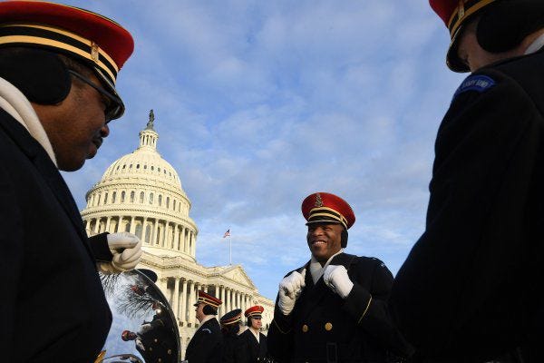 Sgt. First Class David Kirven, left, Master Sgt. Mario Ramsey, center, and Staff Sgt. Zach Bridges, right, of the U.S. Army Band "Pershing's Own" talk during a short break Sunday at the Capitol while rehearsing for Donald Trump's inauguration.