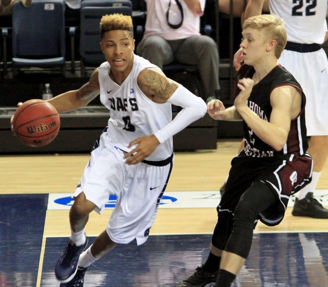 UAFS' Alex Cooper drives along the baseline past an Oklahoma Christian defender last season at the Stubblefield Center. TIMES RECORD FILE PHOTO