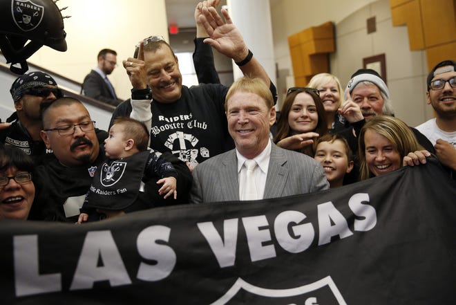 FILE - In this April 28, 2016, file photo, Oakland Raiders owner Mark Davis, center, meets with Raiders fans after speaking at a meeting of the Southern Nevada Tourism Infrastructure Committee in Las Vegas. The Raiders have filed paperwork to move to Las Vegas. Clark County Commission Chairman Steve Sisolak told The Associated Press on Thursday, Jan. 19, 2017, that he spoke with the Raiders. (AP Photo/John Locher, File)