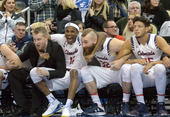 Robert Morris's Nick Lackey (from left), Dachon Burke, Roberto Mantovani and Conrad Stephens celebrate during the Colonials' win over Duquesne at PPG Paints Arena in Pittsburgh.