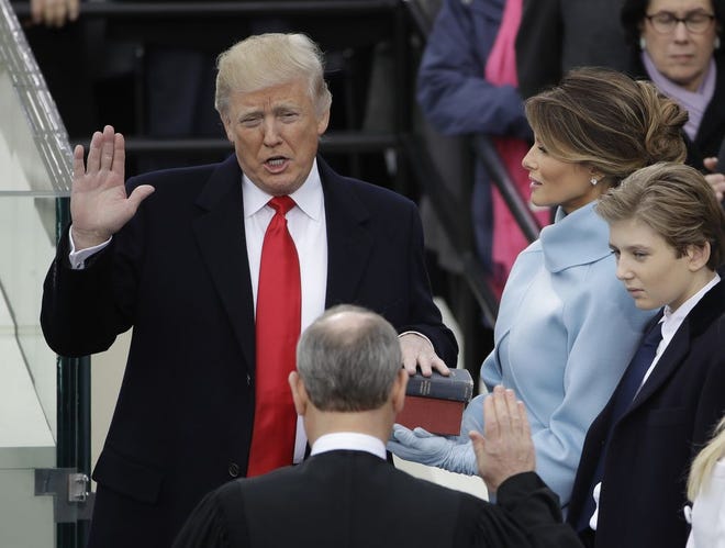 Donald Trump is sworn in today as the 45th president of the United States by Chief Justice John Roberts as Melania Trump looks on.