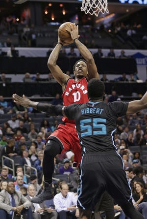 Toronto Raptors' DeMar DeRozan (10) shoots over Charlotte Hornets' Roy Hibbert (55) in Charlotte on Friday. (AP Photo/Chuck Burton)