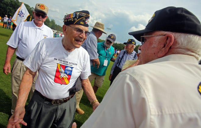 Albert Mancinelli, left, and 17th Airborne Parachute Division buddy Don Watson chat while being honored with other veterans before the start of Game 12 at the American Legion World Series in 2015. Brittany Randolph/The Star