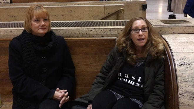 Shari Vandergast (left), of Kitnersville, Pennsylvania, and Maxine Scherz, of Elkins Park, Pa., share why they decided to attend the women's march in Washington, D.C., while they wait at 30th Street Station in Philadelphia early Saturday, Jan. 21, 2017.
