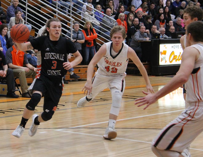 Jonesville's Jake Wilson drives to the basket with several Quincy defenders waiting. TROY TENNYSON PHOTO