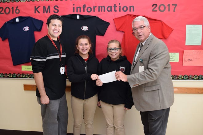 From Kathleen Middle School are Matt Huro, video production instructor, left; Hayley Campos, Samantha Roberts and Chip Brown from Heartland Crime Stoppers. PROVIDED