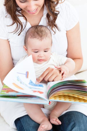 Cuddle up with your baby and look at a book together. (Dreamstime)
