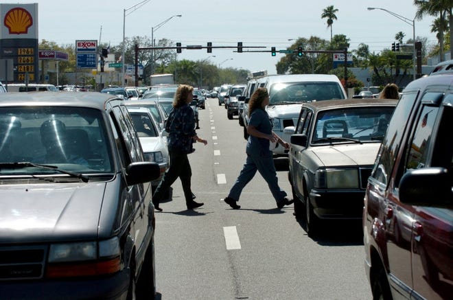 Pedestrians jaywalk across a six-lane section of U.S. 41 in Sarasota. A recent study by Smart Growth America and the National Complete Streets Coalition ranks Sarasota-Manatee as the 10th most dangerous metropolitan area in the United States for pedestrians. PHOTO / HERALD-TRIBUNE ARCHIVES