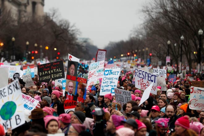 Protesters move along Constitution Avenue at the Women's March on Washington during the first full day of Donald Trump's presidency. (AP Photo/John Minchillo)