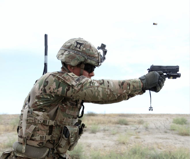 Sgt. Andrew Finneran, a 101st Airborne Division infantryman, fires a Sig Sauer pistol during weapons training in 2015 at Tactical Base Gamberi in eastern Afghanistan. CAPT. CHARLIE EMMONS/US ARMY VIA WASHINGTON POST
