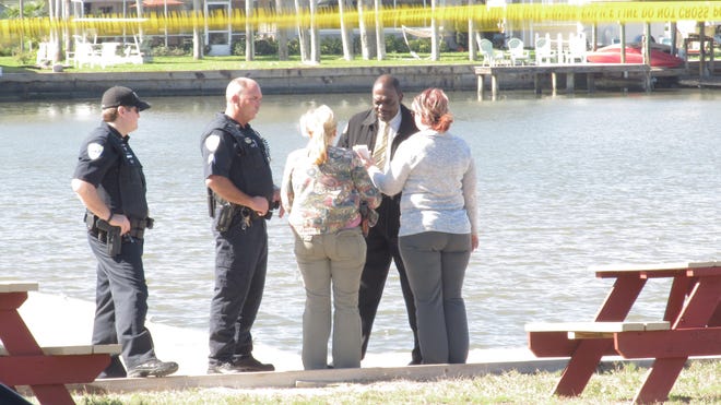 Investigators and medical examiners inspect a boat dock where a woman's body was found late Tuesday morning in a marina behind the Hidden Treasure Raw Bar & Grille in Flagler Beach. NEWS-JOURNAL/Matt Bruce