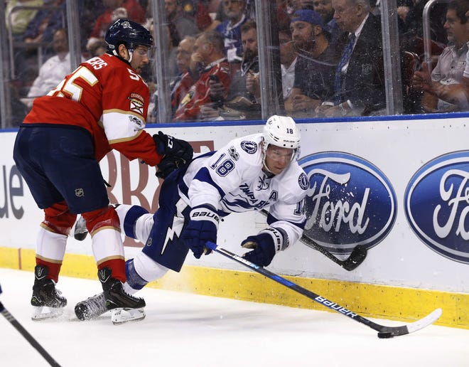 Florida Panthers defenseman Jason Demers (55) and Tampa Bay Lightning left wing Ondrej Palat (18) battle for the puck during the first period of an NHL hockey game, Thursday, Jan. 26, 2017, in Sunrise, Fla. THE ASSOCIATED PRESS / WILFREDO LEE