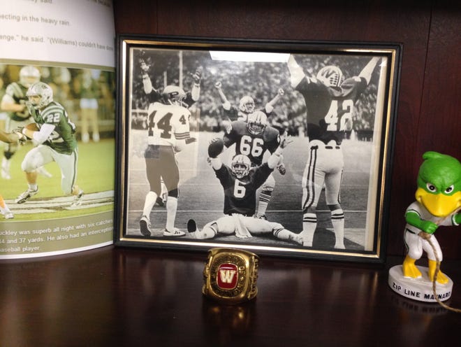 A photo of Wayne Souza celebrating at Wisconsin sits next to a photo of Scott Buckley's son, Drew, on the left. COURTESY PHOTO