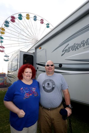 Veteran John Goubeaux and his wife, Vicky, stand outside their RV in the infield of the International Speedway Friday. The North Carolina couple won tickets to the Rolex 24 this weekend in a Gatehouse Media contest. News-Journal/JIM TILLER