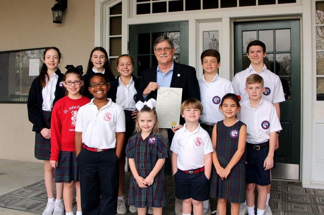 St. John Primary/St. Theresa Middle School students pictured with the Mayor are (front row, left to right): Hayley Cavalier, Robbie Jones, Averie Bourgeois, Easton Leake, Grace Amedee and Luke Reulet; (second row, left to right): Jenna Tramonte, Maggie Decoteau, Ani Richardson, Joshua Wax, and Austin Savoy.