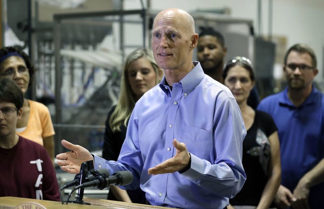 Florida Gov. Rick Scott gestures during a visit to Beneficial Blends on Wednesday. Despite what could be a bruising budget year with competing priorities, Gov. Scott called for $618 million in tax cuts, including a dramatic cut in the sales taxes charged on commercial rents. (AP Photo/Chris O'Meara)