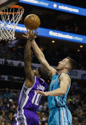 Sacramento Kings guard Ty Lawson, left, drives to the basket past Charlotte Hornets center Frank Kaminsky III in Charlotte on Saturday. (AP Photo/Nell Redmond)