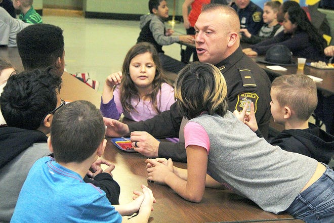 Hillsdale Sheriff's Office Lt. Todd Moore talks with a group of students Friday morning. ANDY BARRAND PHOTO