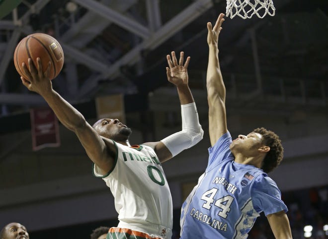 Miami guard Ja'Quan Newton (0) goes to the basket as North Carolina forward Justin Jackson (44) defends in the first half of an NCAA college basketball game, Saturday, Jan. 28, 2017, in Coral Gables, Fla. (AP Photo/Alan Diaz)