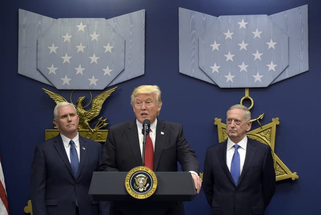 President Donald Trump, center, flanked by Vice President Mike Pence, left, and Defense Secretary James Mattis, speaks during an event at the Pentagon in Washington on Friday. A U.S. military servicemember was killed during a raid in Yemen on Sunday, the first-known combat death of a member of the U.S. military under Trump. (AP Photo/Susan Walsh)