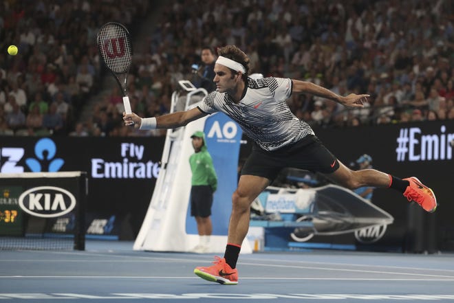 Switzerland's Roger Federer makes a backhand return to Spain's Rafael Nadal in the men's singles final at the Australian Open tennis championships in Melbourne, Australia, Sunday, Jan. 29, 2017. (Scott Barbour/Pool via AP)