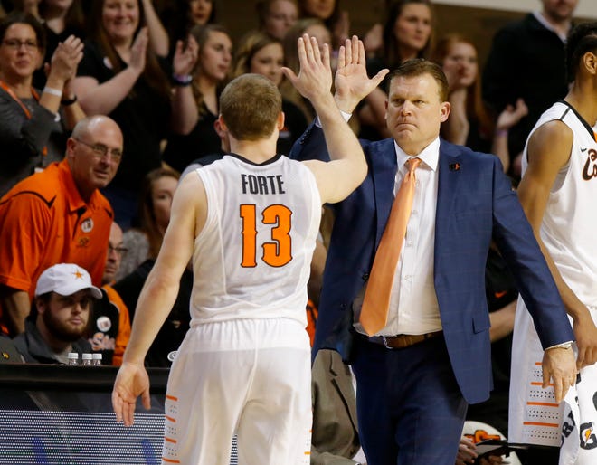 Oklahoma State coach Brad Underwood slaps hands with Phil Forte III (13) after Forte broke Oklahoma State's record for most career 3-pointers. [PHOTO BY BRYAN TERRY, THE OKLAHOMAN]