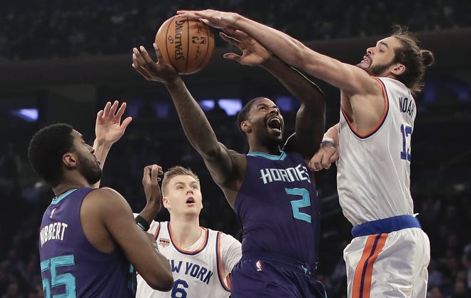 Charlotte Hornets forward Marvin Williams is fouled by New York Knicks center Joakim Noah during the first quarter of Friday's game in New York. (AP Photo/Julie Jacobson)