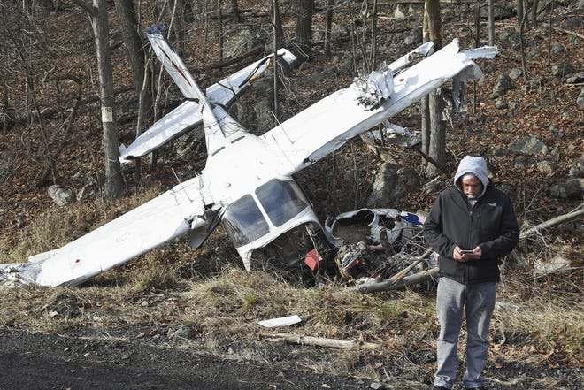 Pilot John Ruble, Allentown, Pa., stands in front of the Cessna P210 airplane he was forced to crash land in on Rt. 901 in Foster Township., Pa., Monday, Jan. 30, 2017. Ruble cited engine failure for the crash. Ruble and his passenger were enroute from Allentown, Pa., to Ohio and both walked away from the crash escaping serious injury. (Jacqueline Dormer/The Republican-Herald via AP)
