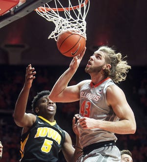 Illinois forward Michael Finke (43) makes a basket against Iowa forward Tyler Cook (5) during the first half of an NCAA college basketball game in Champaign, Ill., Wednesday, Jan. 25, 2017. (AP Photo/Heather Coit)