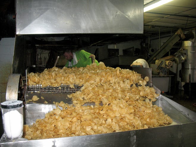 Freshly made chips spill out of the fryer at Corell's Potato Chips' Beach City manufacturing facility.

(For IndeOnline.com / Joe Shaheen)