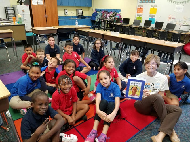 Bobbi Bordes, a volunteer with the Books for Kids organization, reads to a group of children at Gocio Elementary School in Sarasota. Courtesy of Ted Lindenberg
