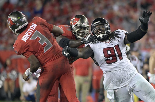 In this Nov. 3, 2016, file photo, Tampa Bay Buccaneers quarterback Jameis Winston (3) throws a pass as tackle Demar Dotson (69) blocks Atlanta Falcons defensive tackle Courtney Upshaw (91) during the second half of an NFL game in Tampa. Though they will be on opposite sidelines in Sunday's Super Bowl, there is a ton of respect between Patriots linebacker Dont'a Hightower and Upshaw, an Atlanta Falcons linebacker. The duo were roommates at Alabama. FILE PHOTO / THE ASSOCIATED PRESS